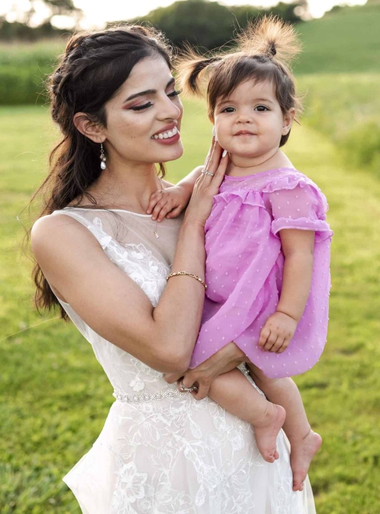 3D ultrasound technologist standing with her daughter in a corn field while wearing a wedding dress